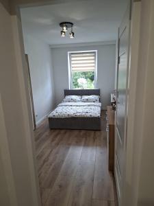 a bedroom with a bed and a window at NOVA Apartament Podgórze in Wałbrzych
