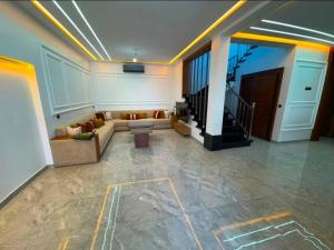a living room with a couch and a staircase at villa la perle in Asilah