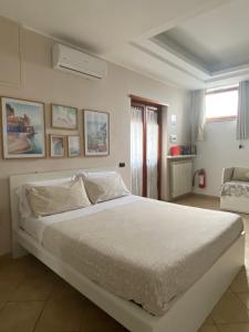 a bedroom with a large white bed in a room at Carla's studio in Pompei