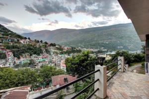 a view of a city from a balcony at Hotel O Shishamaati in Kulu