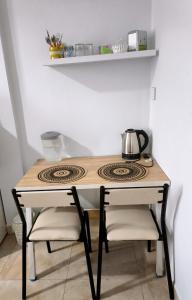 a kitchen table with a stove in a room at Departamento Letty Petit - Con Cochera in San Salvador de Jujuy