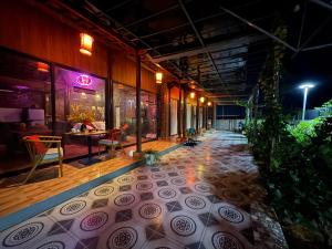 a building with a patio with a table and chairs at Son House in Dong Hoi