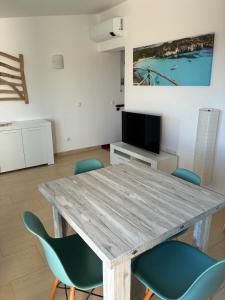 a dining room with a wooden table and chairs at Apartamento Sa Perdiu 16 in Son Carrio