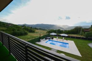 a view from the balcony of a house with a swimming pool at Koala Resort in Raška