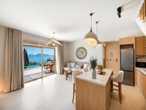 a kitchen and living room with a view of the ocean at Villa Magganas in Nikiana