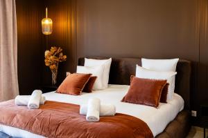 a bedroom with a large bed with towels on it at Villa Maya Rooftop beach access heated pool in Le Grau-dʼAgde