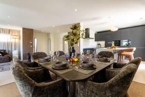 a dining room and kitchen with a table and chairs at Villa Maya Rooftop beach access heated pool in Le Grau-dʼAgde