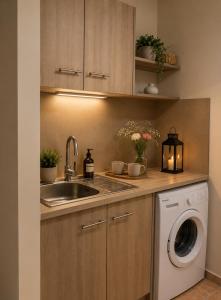 a kitchen with a sink and a washing machine at Rouchotas Studios by Viktor 1rst Floor in Argostoli +66 photos