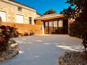 a parking lot in front of a building with a garage at Clos des Voluptés in Fargues-Saint-Hilaire