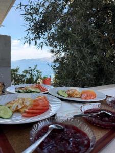 a table with four plates of food on it at Villa Besnik in Sarandë