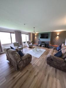 a living room with two couches and a television at Quholmslie Farm Self-Catering in Stromness