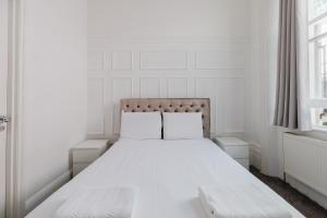 a white bed with two pillows in a bedroom at The Hyde Hotel in London