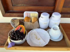 a wooden tray with plates and bowls of food at Brisa da Mata suítes BF in Baía Formosa