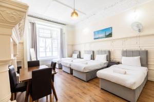 a living room with four couches and a table at The Hyde Hotel in London