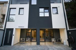 a black and white building with chairs and tables at RiverSide Apartments in Veles
