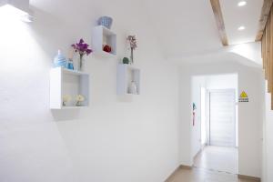 a hallway with white walls and white shelves at GioLì in Matino +38 photos