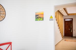 a hallway of a house with a clock on the wall at GioLì in Matino