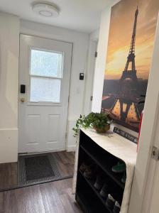 a room with a door and a painting of the eiffel tower at Victoria BNB in Victoria