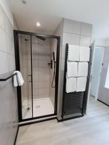 a bathroom with a shower with white towels at The Old Surgery in Blaenau-Ffestiniog +17 photos