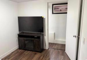 a flat screen tv sitting on a stand in a room at Victoria BNB in Victoria