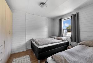 a bedroom with two beds and a window at Apartment in Tromsdalen in Tromsø