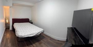 a small bedroom with a bed and a flat screen tv at Victoria BNB in Victoria +16 photos
