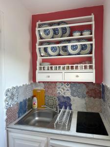 a kitchen with a sink and a counter with plates at Hector -Sweet home with a beautiful view in Agia Marina