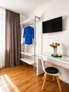 a white room with a desk and a blue shirt on a shelf at Corso Venezia in Mestre