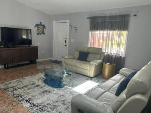a living room with a couch and a coffee table at Blue Beach Pool House in Port Orange