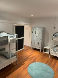a dorm room with bunk beds and a rug at Dormitorio no Porto in Porto +11 photos