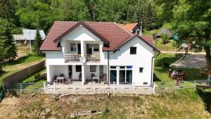 a white house on top of a hill at Apartments Stari Jasen Uvac in Sjenica