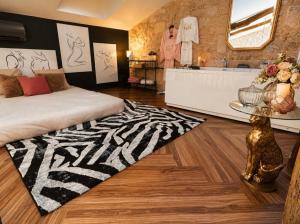 a bedroom with a zebra print rug and a bathroom at Clos des Voluptés in Fargues-Saint-Hilaire +50 photos