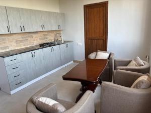 a kitchen with a table and two chairs and a counter at Sargis guest house in Ushi