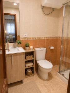 a bathroom with a toilet and a sink and a shower at Punta Umbria Apartment in Punta Umbría