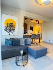 a living room with a blue couch and a table at Animus Premium apt in Nafplio