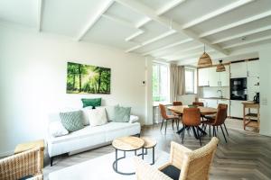 a living room with a white couch and a table at ReCenter in Brecht