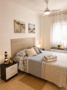 a bedroom with a large bed and a ceiling at Punta Umbria Apartment in Punta Umbría