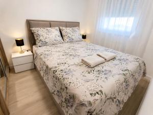 a bed with two pillows on it in a bedroom at Tulipan LUX in Doboj