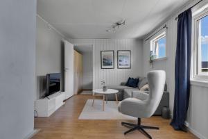 a living room with a couch and a chair at Apartment in Tromsdalen in Tromsø