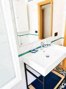 a bathroom with a white sink and a mirror at Casa Mansi in Vietri sul Mare +5 photos
