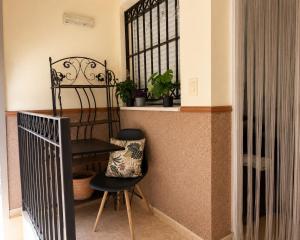 a chair and a table in a room with a window at Punta Umbria Apartment in Punta Umbría