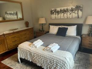 a bedroom with a bed with two towels on it at Blue Beach Pool House in Port Orange +24 photos