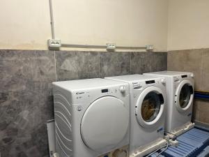 a washing machine and a dryer in a bathroom at Ferra Hostel in Durrës