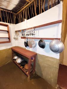 a kitchen with pots and pans hanging from a wall at Sunset Paradise Talalla in Talalla South +18 photos