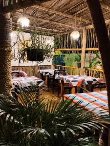 a restaurant with tables and chairs and potted plants at Sunset Paradise Talalla in Talalla South