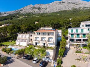 an aerial view of a building with a mountain in the background at Apartments Villa Medic in Brela