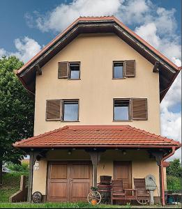 a house with a roof with a porch at Udobna hiša med vinogradi blizu Vinarium LEND - Comfortable Vineyard House near Vinarium Tower LEND in Lendava