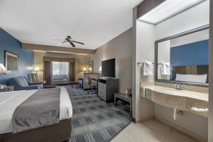 a hotel room with a bed and a bathroom at Best Western Geneseo Inn in Geneseo +41 photos