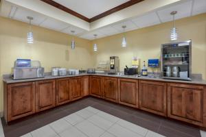 a large kitchen with wooden cabinets in a room at Best Western Geneseo Inn in Geneseo
