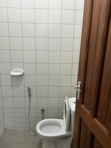 a bathroom with a toilet and a shower at Central Calm Apartment in Dar es Salaam